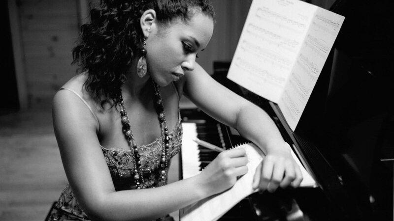 woman writing at piano