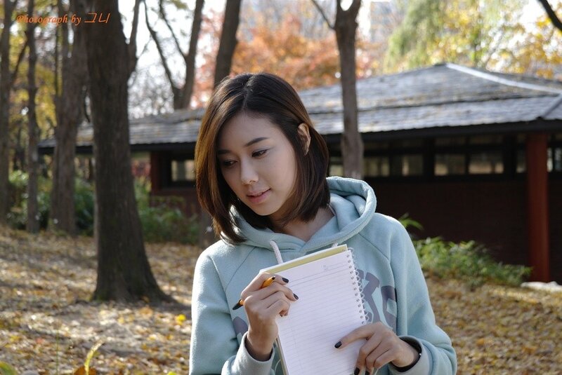woman writing in notebook outdoors