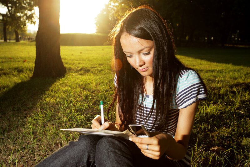 woman writing in park