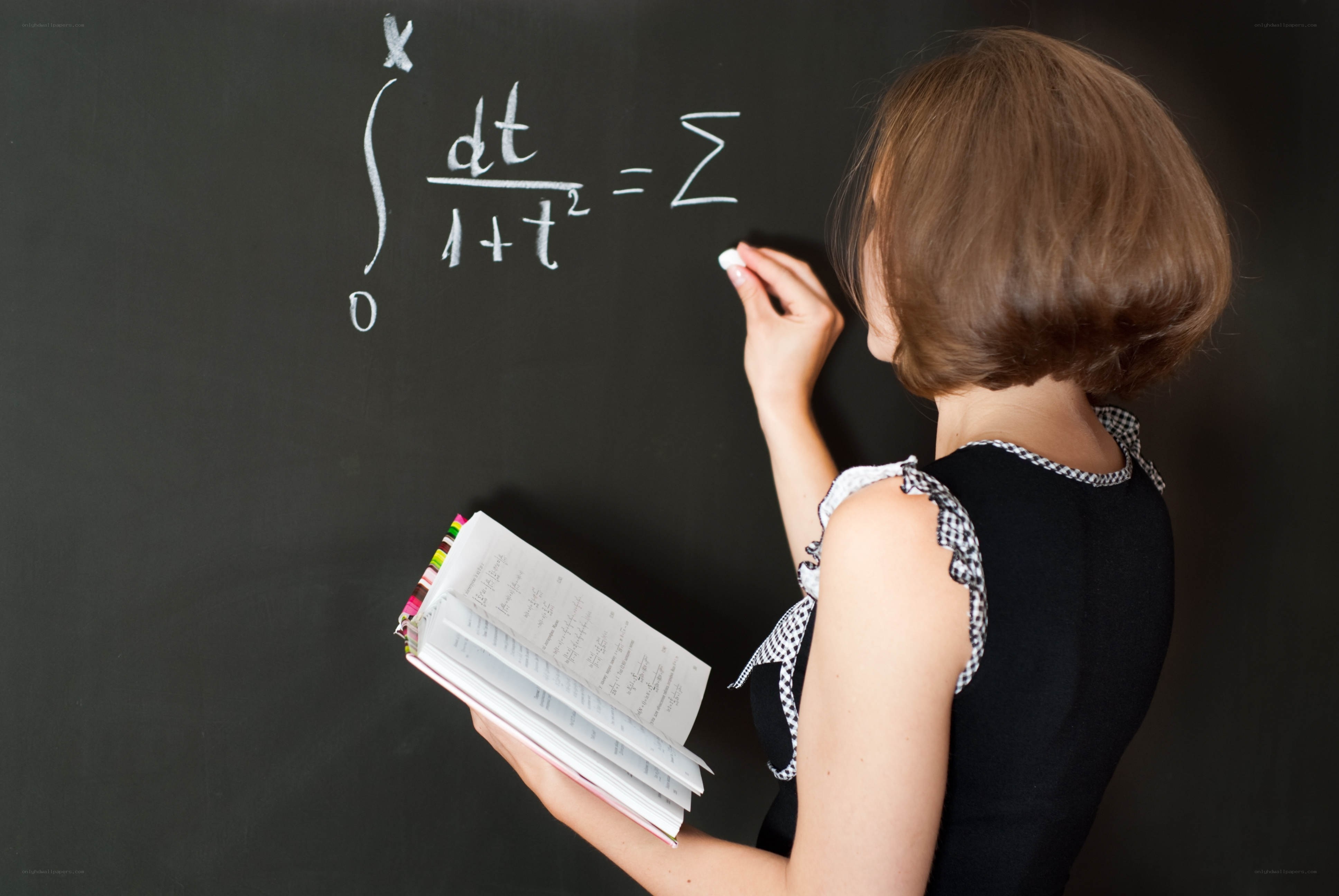 woman writing math on chalkboard