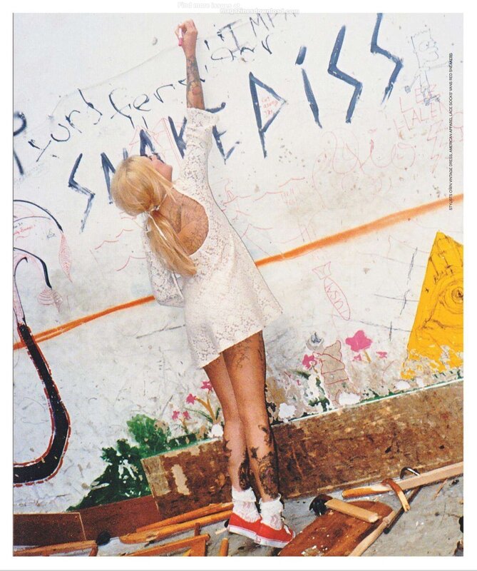 woman writing on a graffiti wall