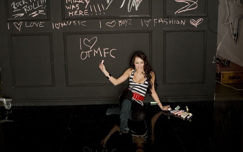woman writing on chalkboard