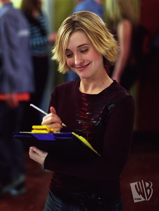 woman writing on clipboard