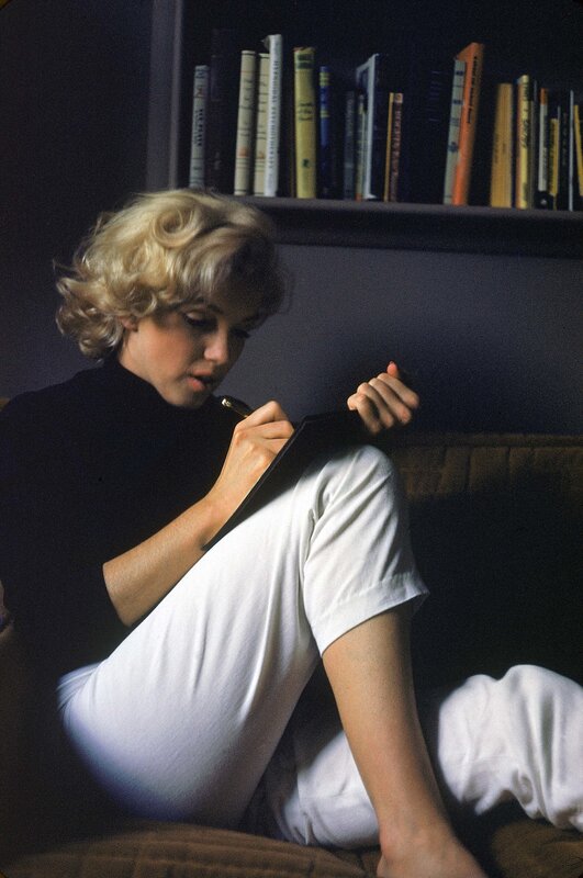 woman writing on couch