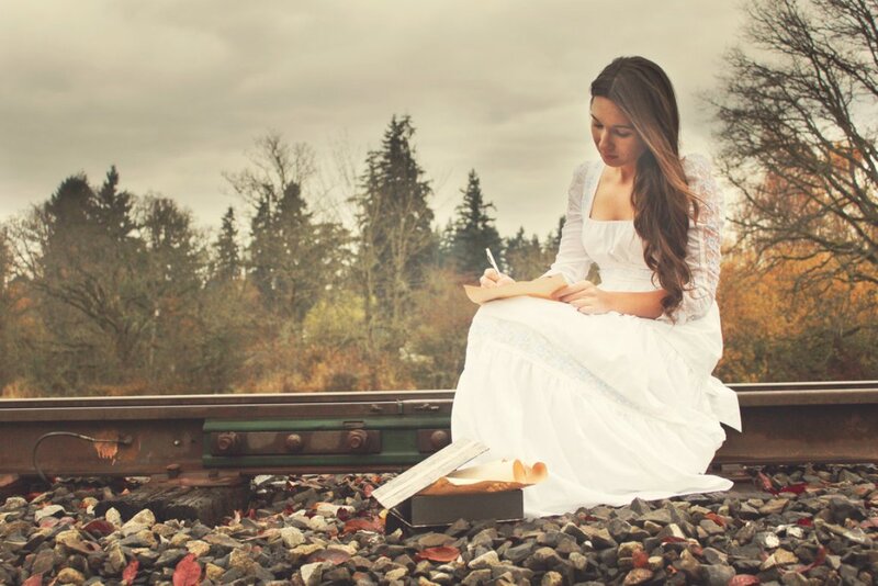 Woman Writing on Train Tracks