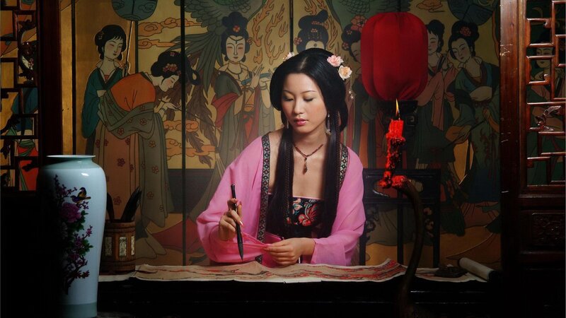 woman writing with brush