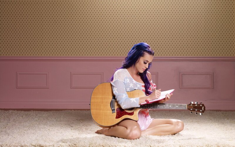 woman writing with guitar