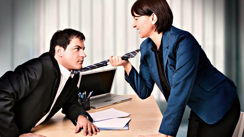 Woman yelling at man in office