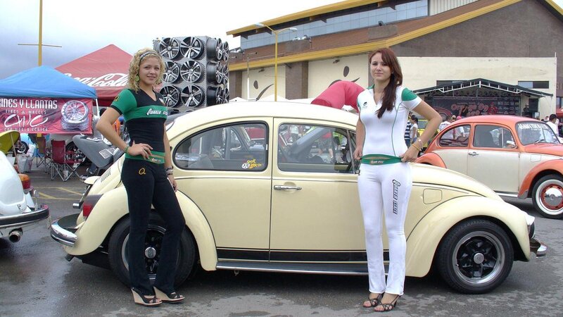 Women at a car show with classic cars