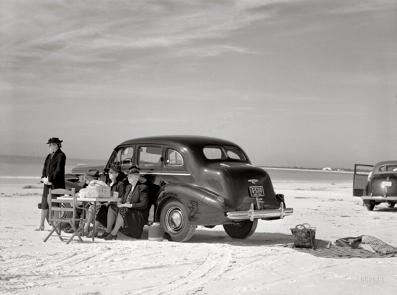 Women at beach with vintage car