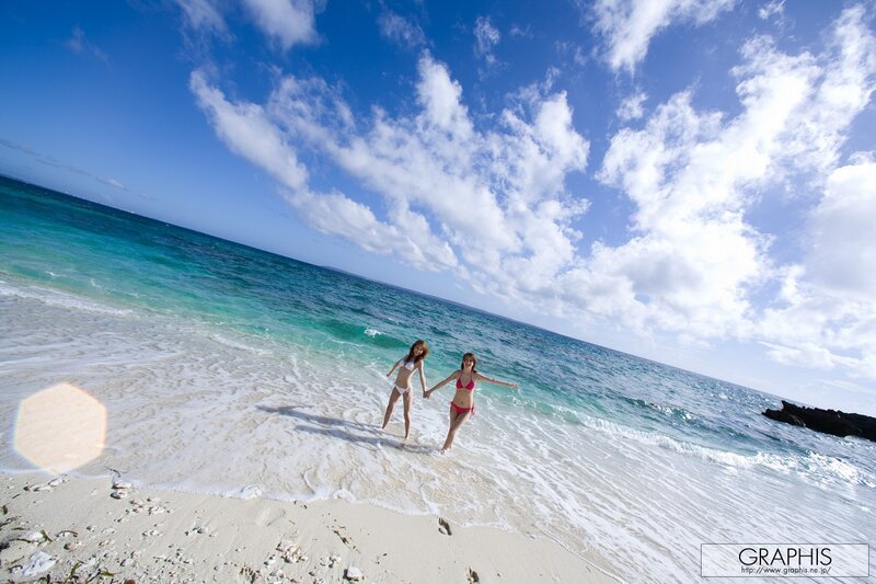 Women at the beach holding hands