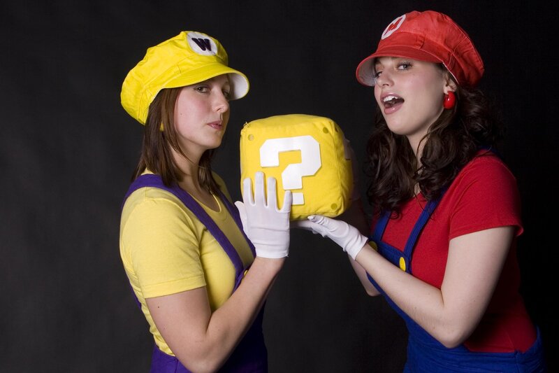 Women cosplaying as Mario and Luigi