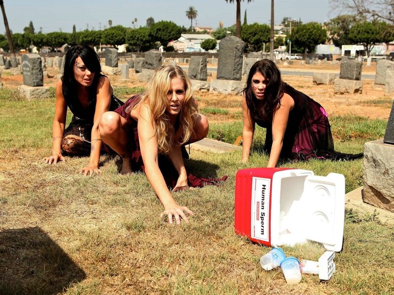 Women crawling in a cemetery
