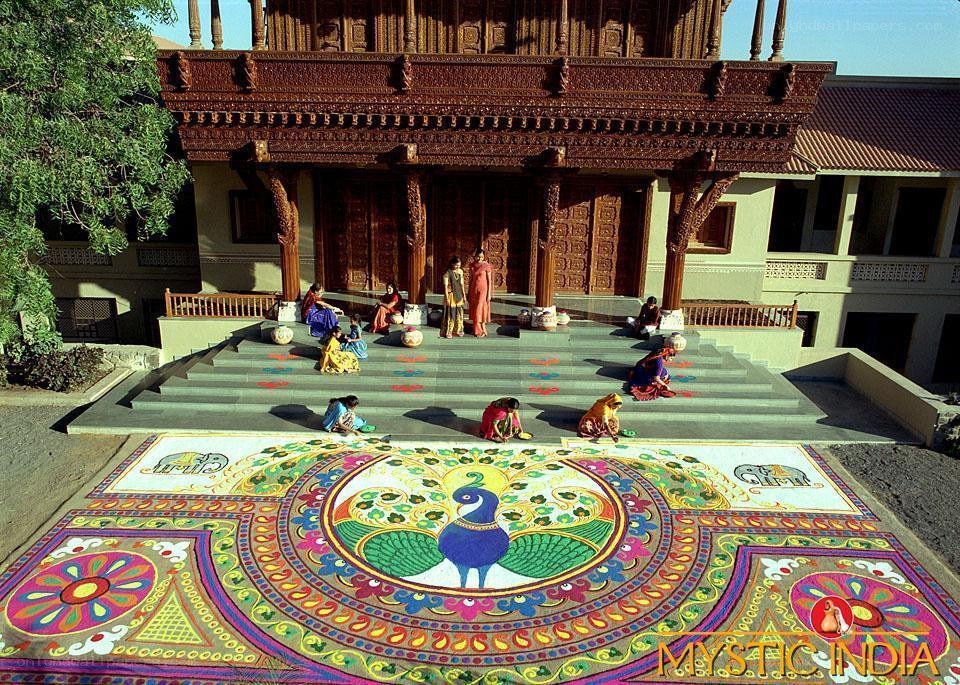 Women creating rangoli art