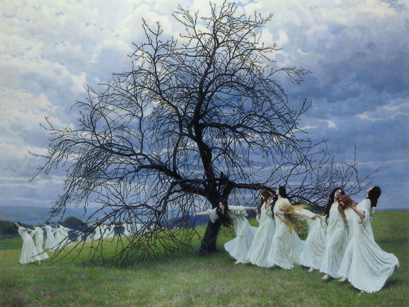 Women dancing around a bare tree