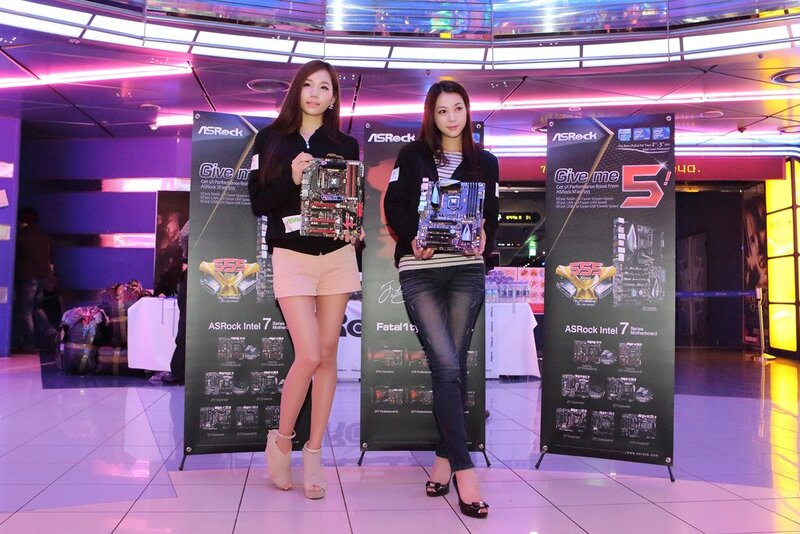 Women holding motherboards at event