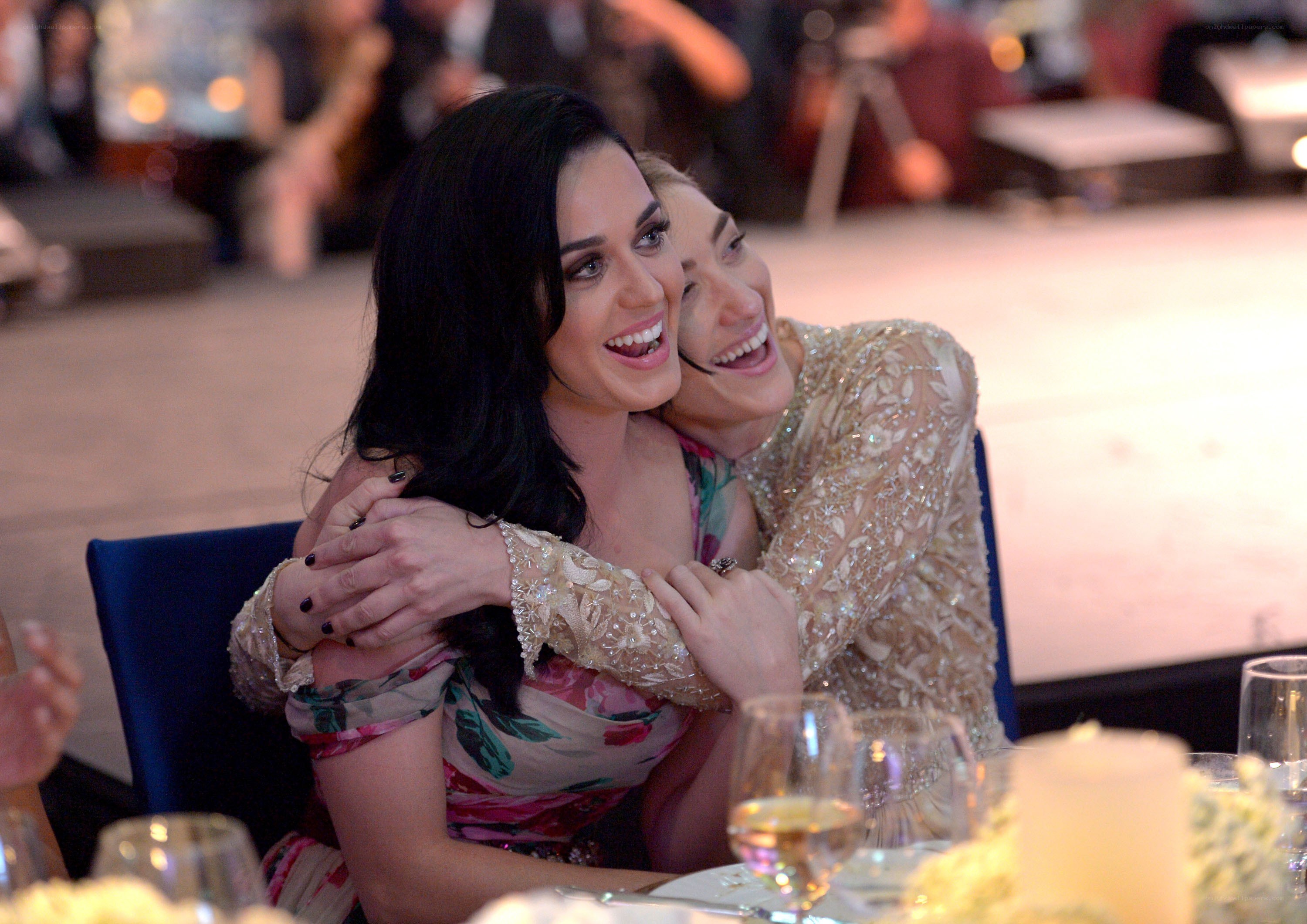 Women hugging at formal event