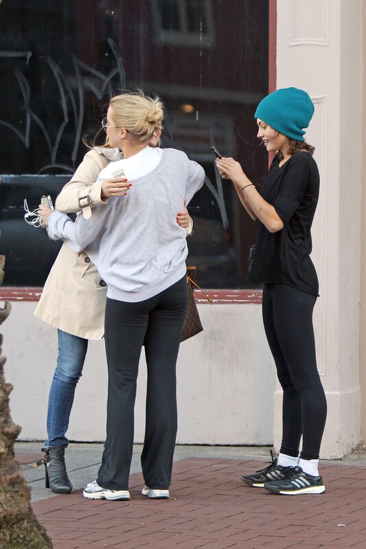 Women hugging on sidewalk
