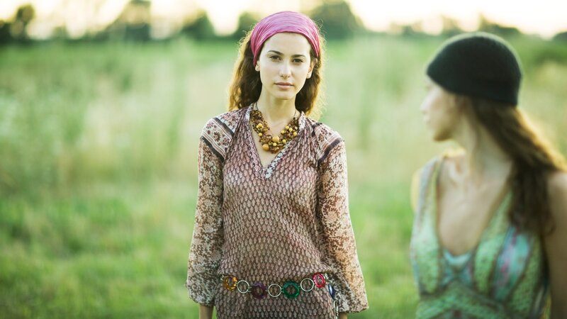 Women in a field at sunset
