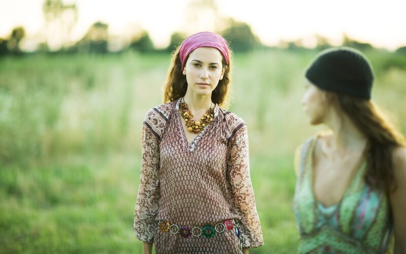 Women in a field at sunset