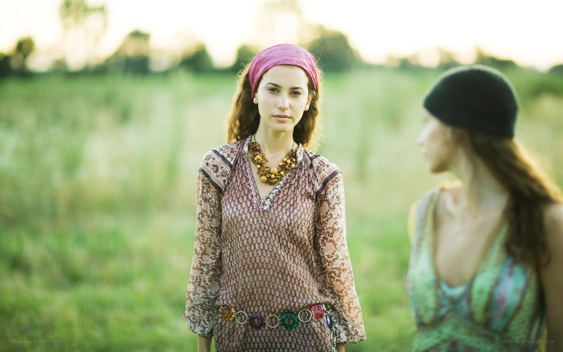Women in a field at sunset