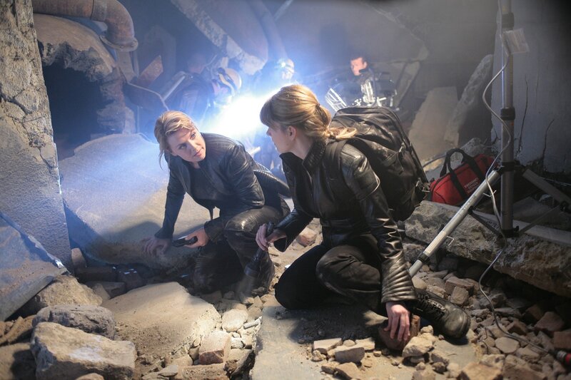 Women in a rubble-filled tunnel