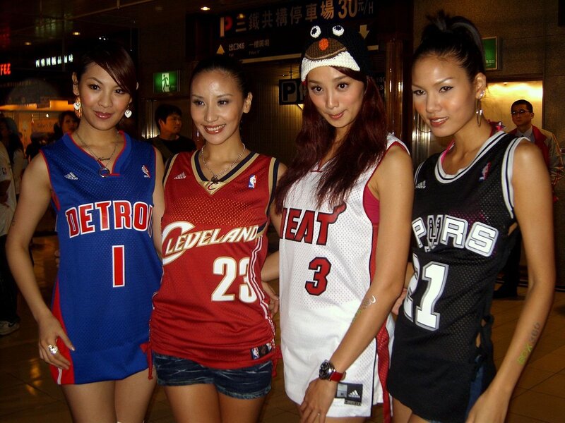 Women in basketball jerseys at event