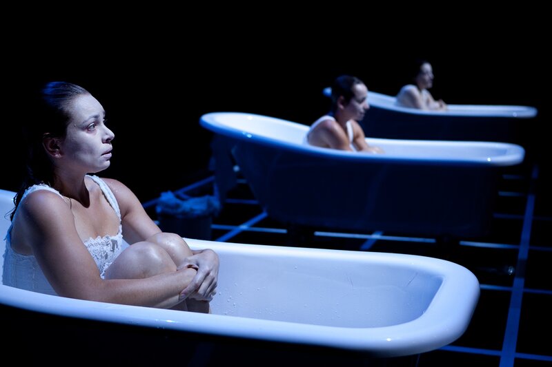 Women in bathtubs on stage