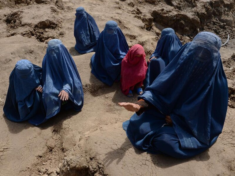 Women in Burqas Sitting