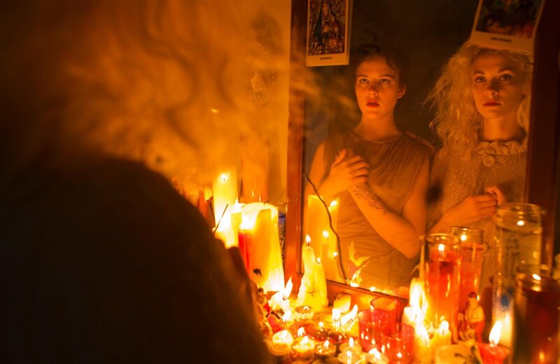 Women in candlelit reflection