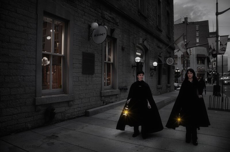Women in cloaks with lanterns