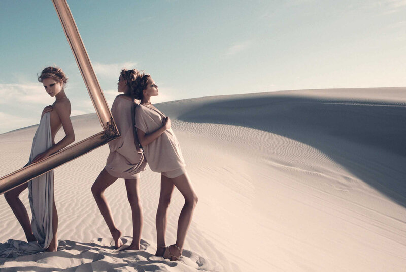 Women in desert with mirror