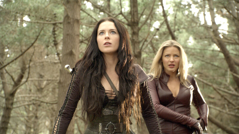 women in forest with swords