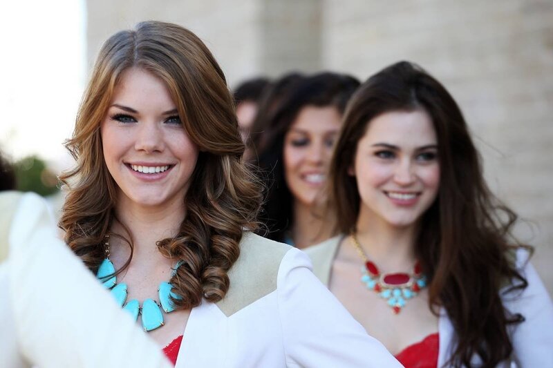 women in formal wear smiling