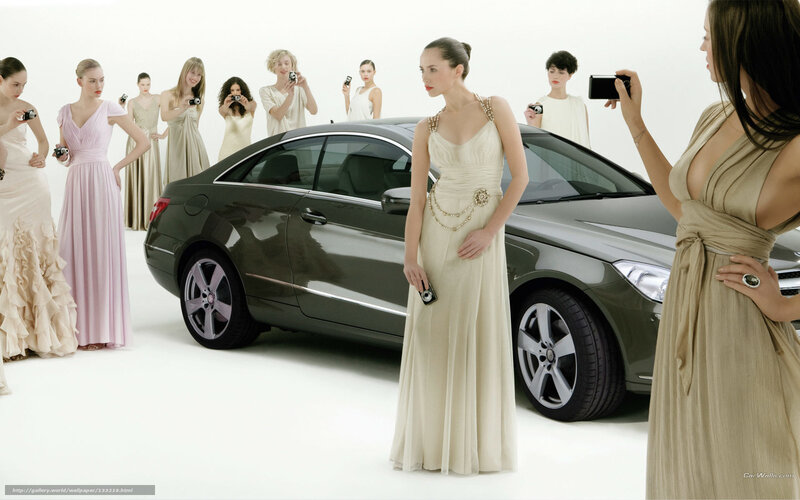 Women in gowns with luxury car