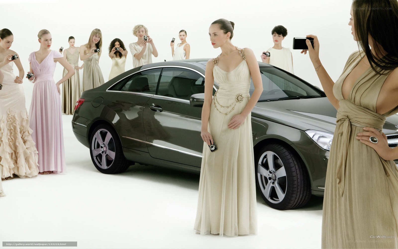 Women in gowns with luxury car