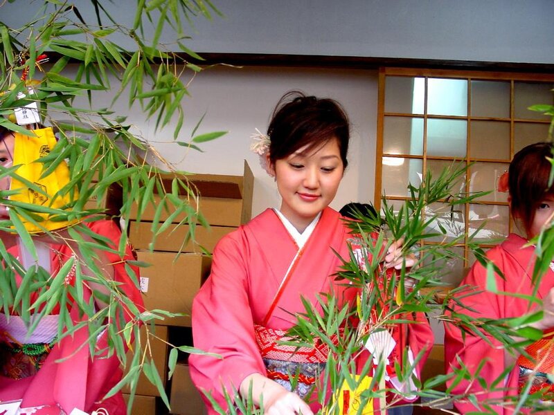 Women in kimonos with bamboo