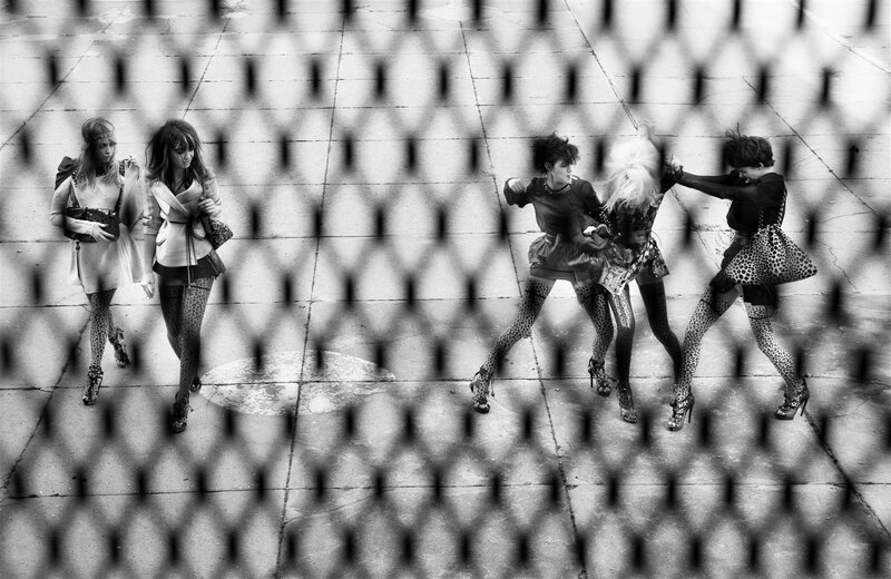 Women in leopard print through fence