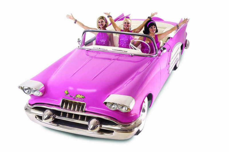 Women in pink convertible car