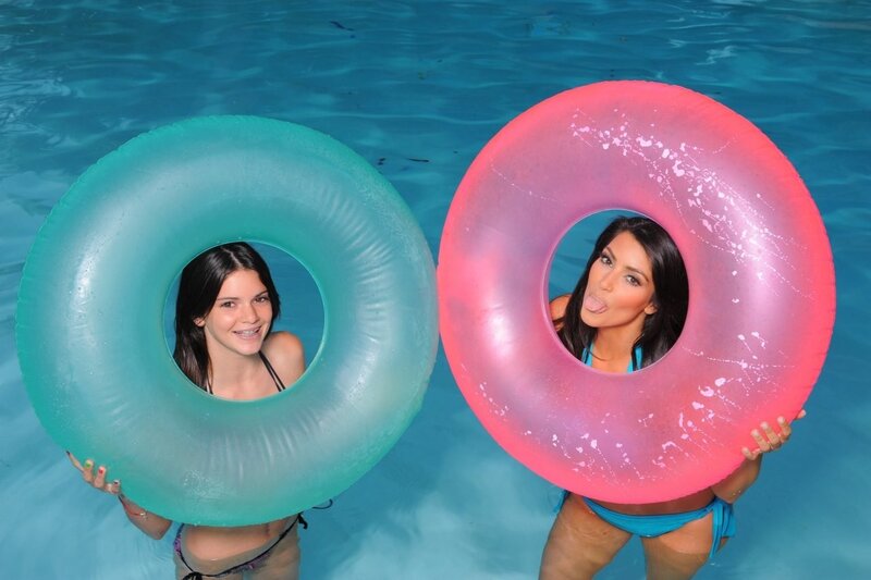 Women in pool with floaties