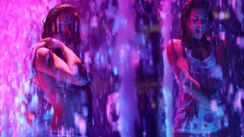 women in rain with purple lights