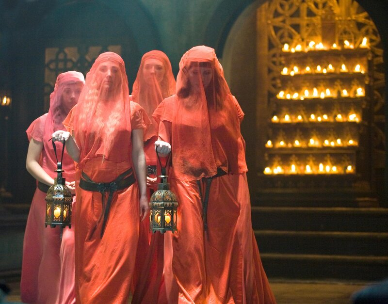 Women in red robes with lanterns