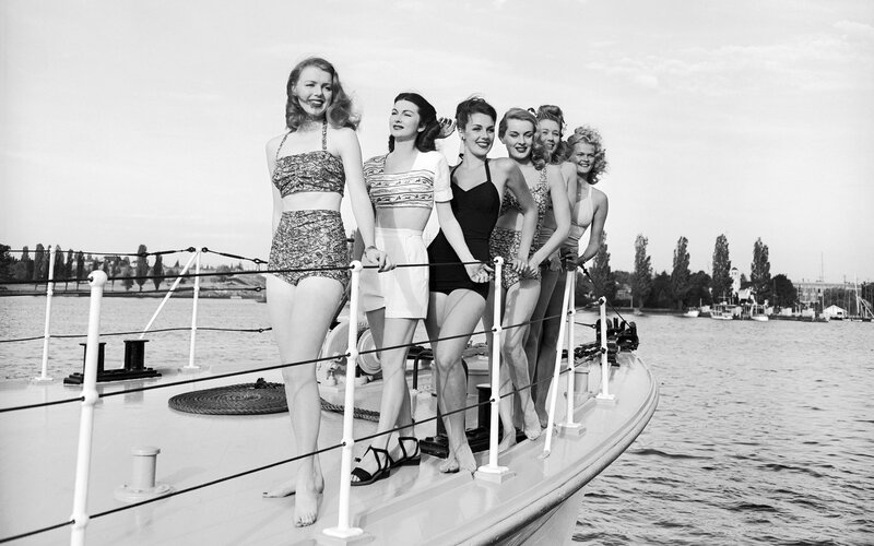 Women in swimsuits on a boat