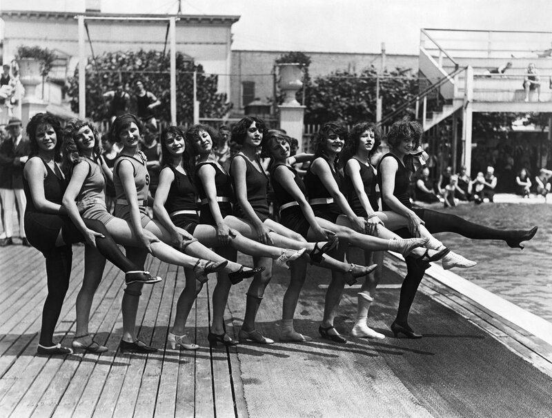 Women in swimwear on a dock