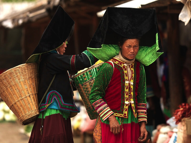 Women in traditional attire carrying baskets