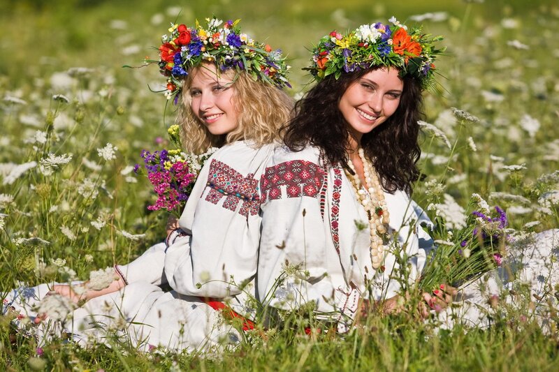 Women in traditional dress with flower crowns