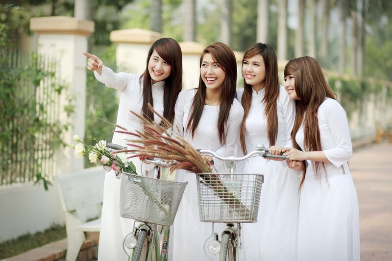 Women in traditional dresses with bicycles