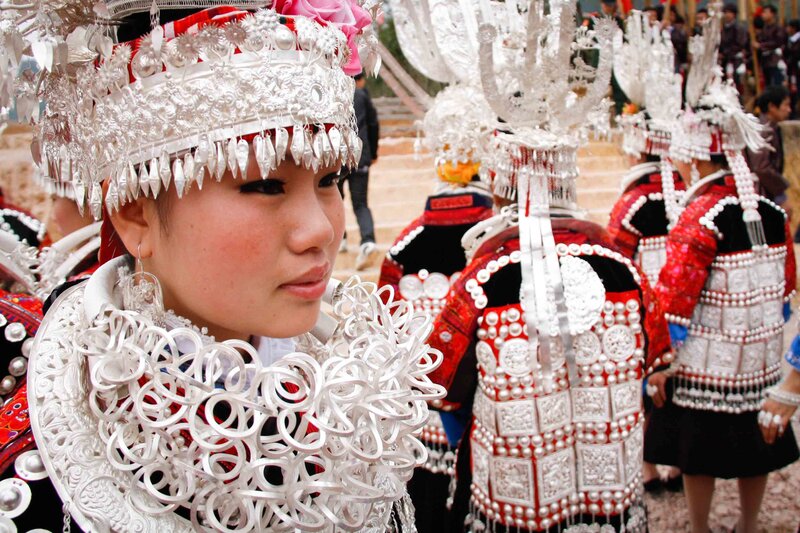 Women in traditional silver headdresses