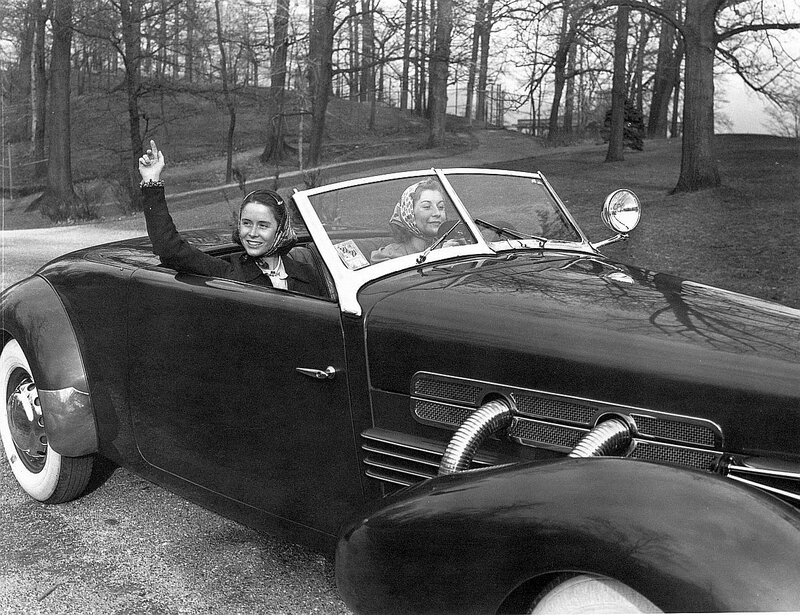 Women in vintage convertible car