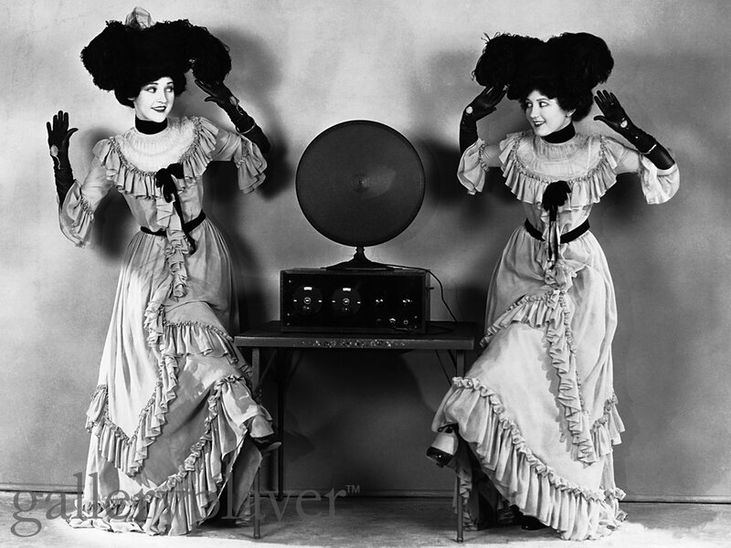 Women in vintage dresses with phonograph